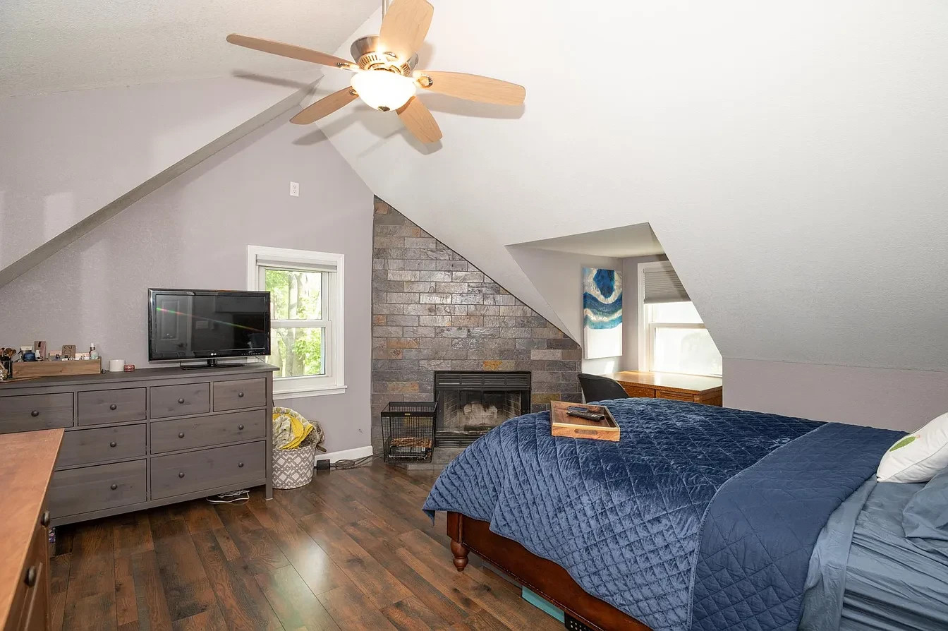 Bedroom — attic suite with vaulted ceiling and stone fireplace