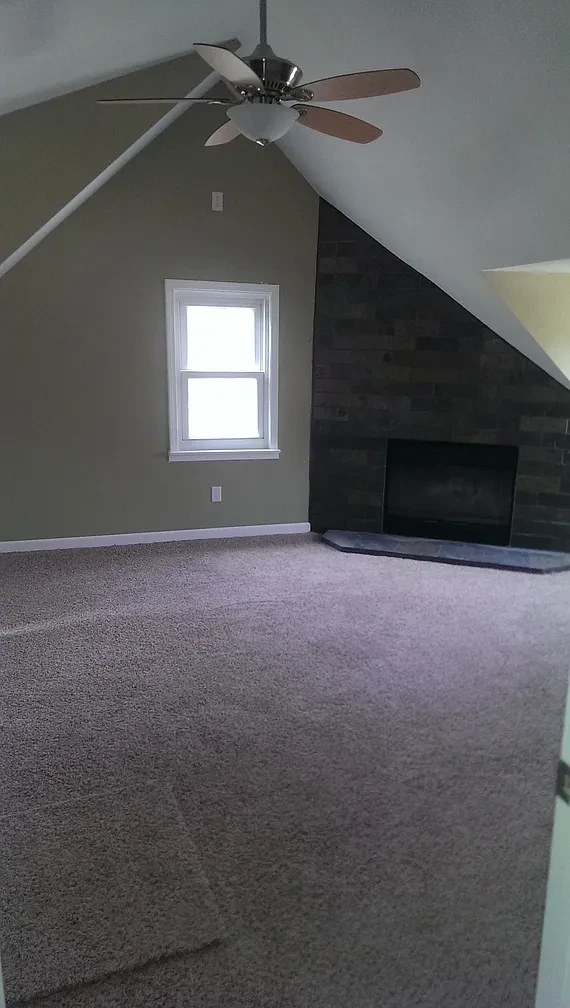 Bedroom — vaulted ceiling with green walls and hardwood floors