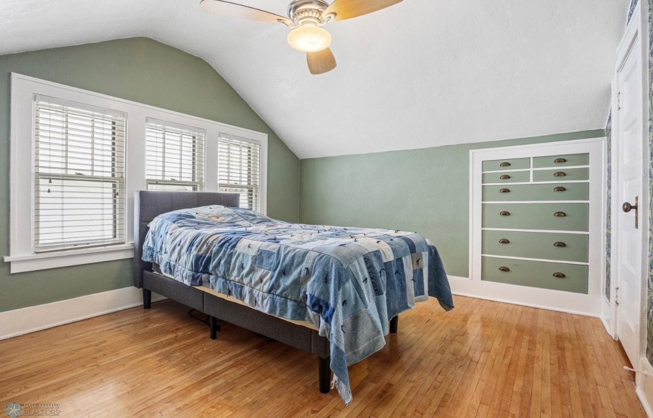 Bedroom — sage green walls with vaulted ceiling and hardwood floors