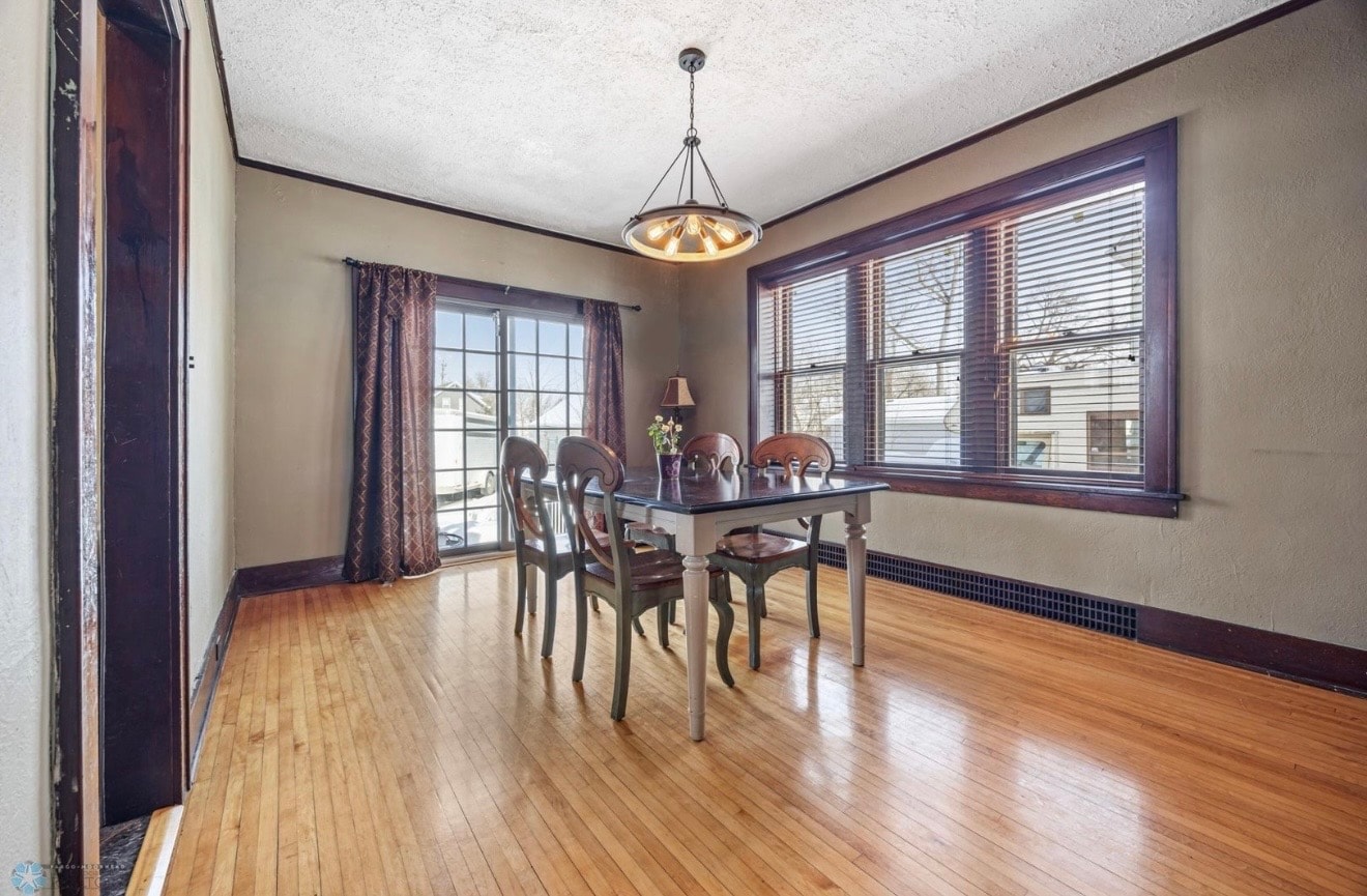 Dining room — craftsman style with pendant light, dark wood trim and hardwood floors