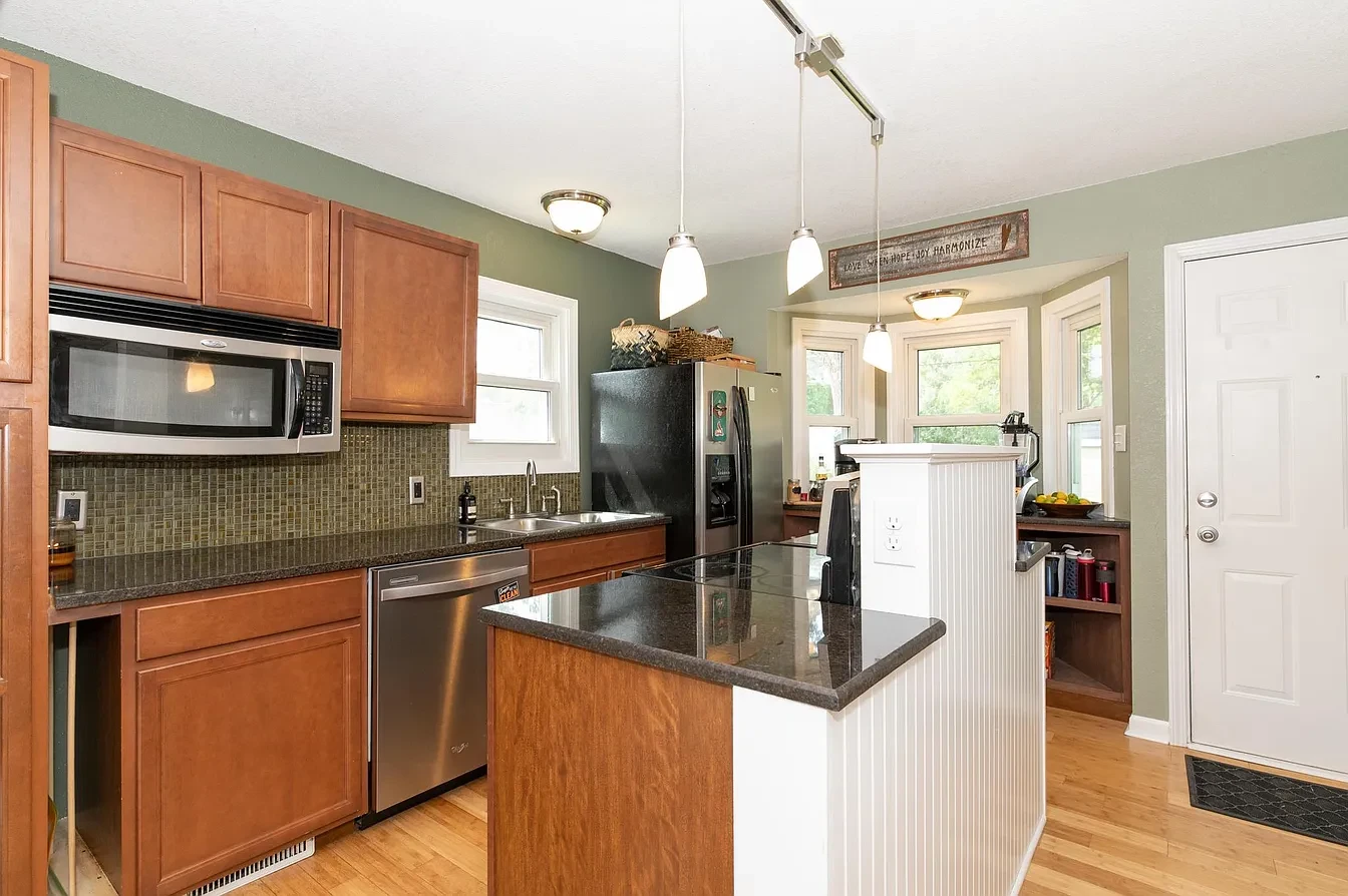 Exterior — red craftsman bungalow with yellow trim, winter street view