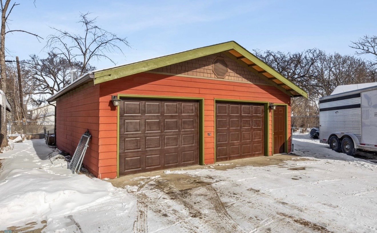 Exterior — detached two-car garage with red siding and green trim
