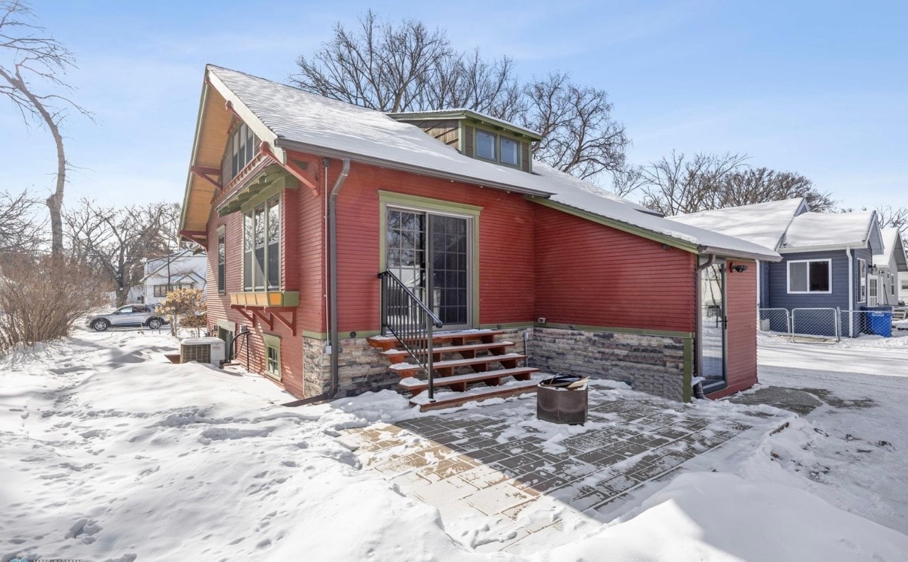 Exterior — red craftsman rear patio with stone foundation and wood steps
