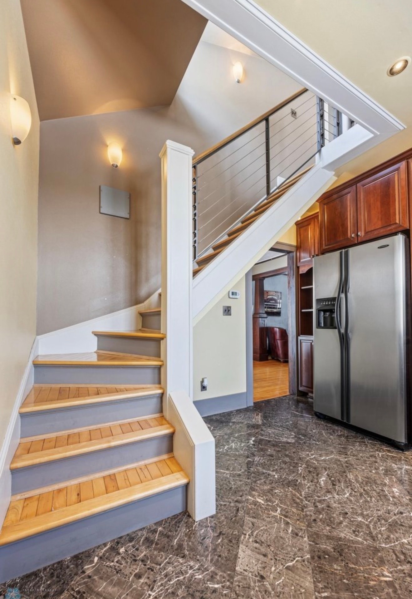 Kitchen — staircase with cable railing, cherry cabinets and marble tile floor