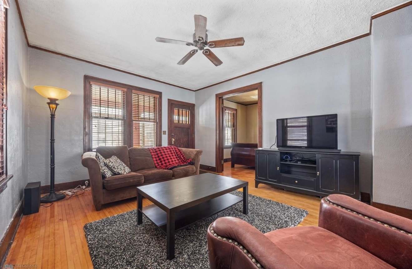 Living room — craftsman with leather furniture, ceiling fan and craftsman entry door