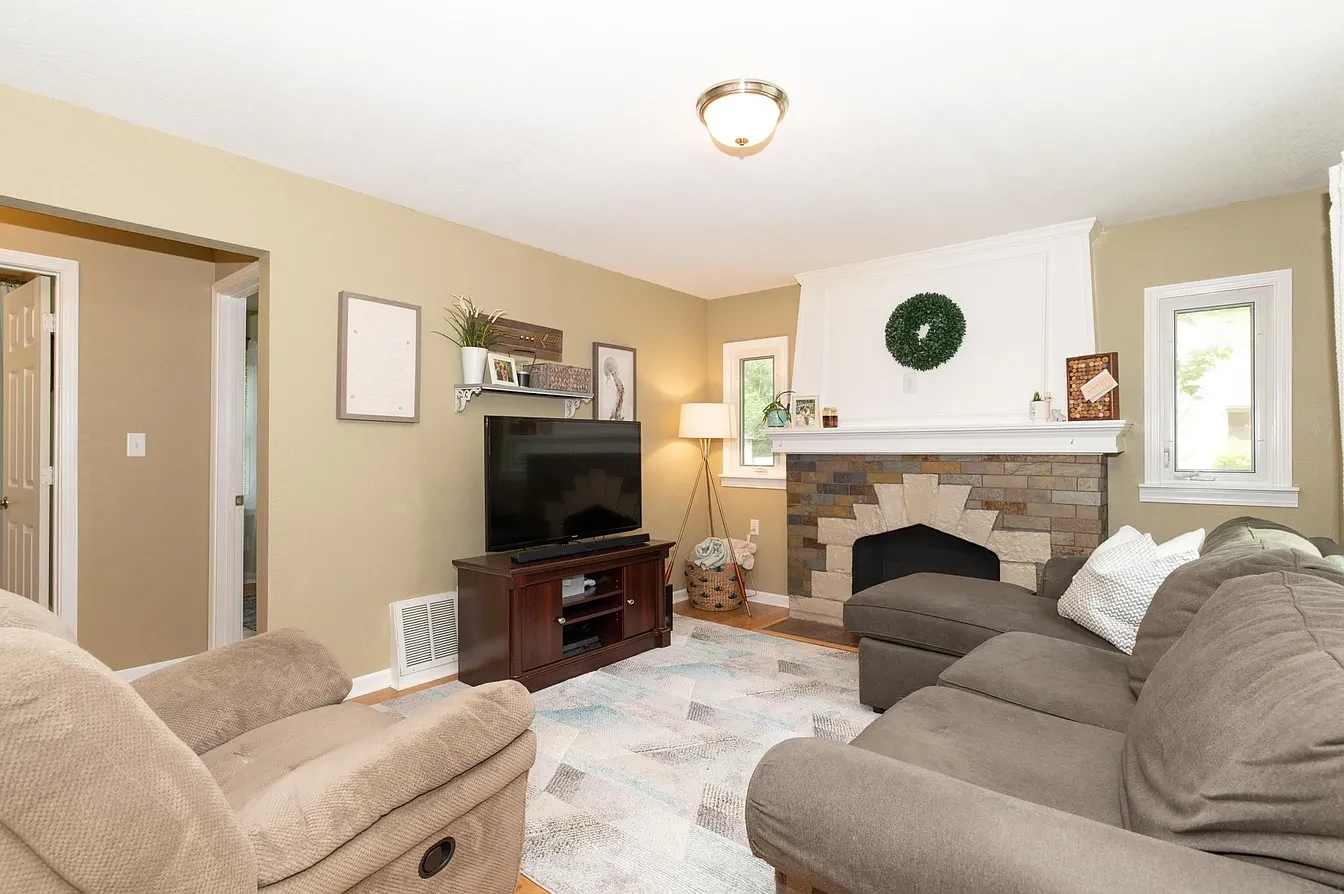 Living room — stone fireplace with TV wall and sectional sofa