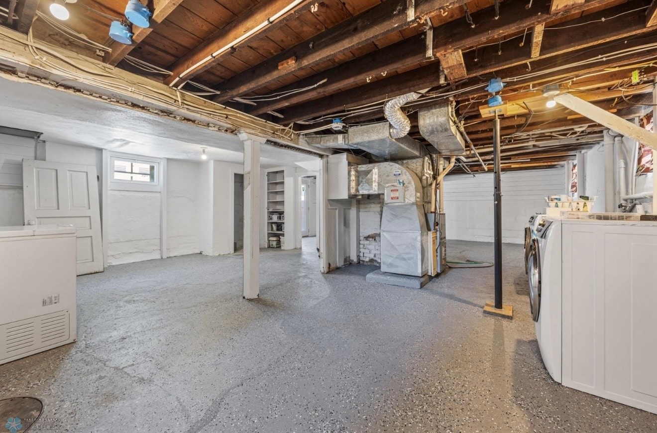Basement — wide view of unfinished basement with laundry area and HVAC