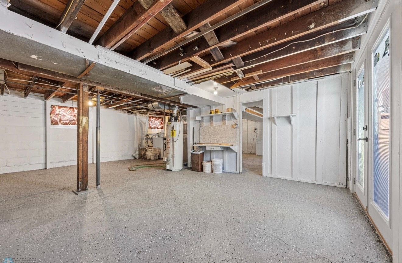 Basement — unfinished utility space with exposed beams and concrete floor