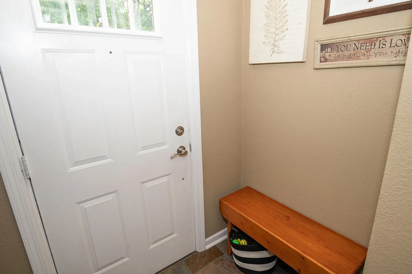 Miscellaneous — entryway with white door and wood bench