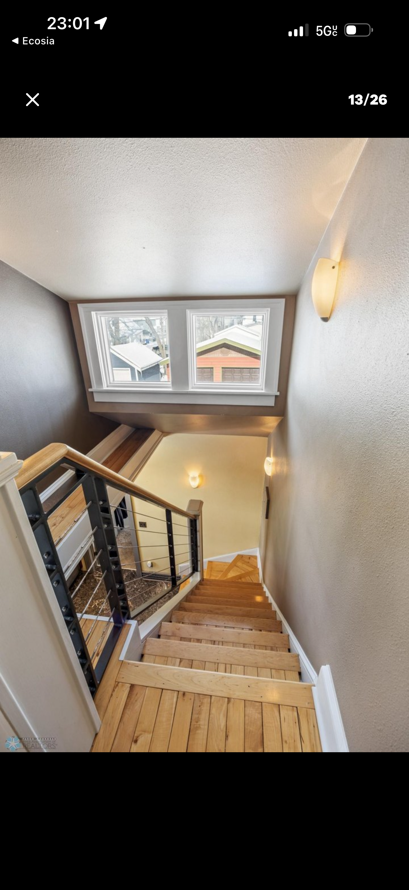 Stairwell — looking down open staircase with cable railing and wall sconces
